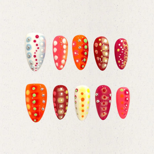 Amber Waves nails showcase golden and silver fluid lines over rich amber and beige backgrounds, offering a sophisticated and organic aesthetic.