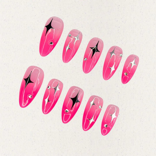 Cosmic Aurora nail set features lilac and pink swirls with silver highlights, star-like motifs, and rhinestone embellishments, creating a celestial and ethereal design.