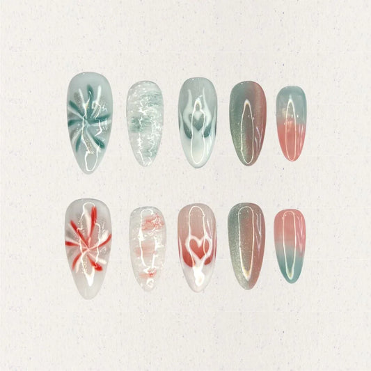 Ocean Reverie nail set combines aqua blues and coral pinks with wave patterns, soft floral motifs, and gradient fades, encapsulating the peaceful beauty of a coastal escape.