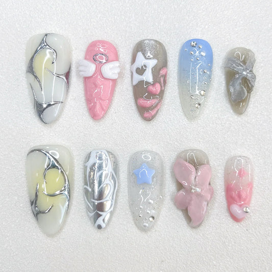 Celestial Dreams press-on nails with soft blue tones, metallic silver accents, and celestial-inspired moon and star decorations for a heavenly finish.