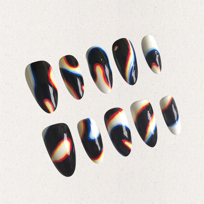 Press-on nails featuring abstract swirls in black, white, red, yellow, and blue, evoking a modern and cosmic aesthetic.