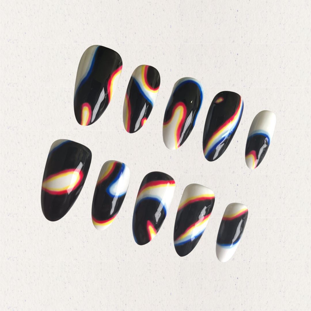 Press-on nails featuring abstract swirls in black, white, red, yellow, and blue, evoking a modern and cosmic aesthetic.