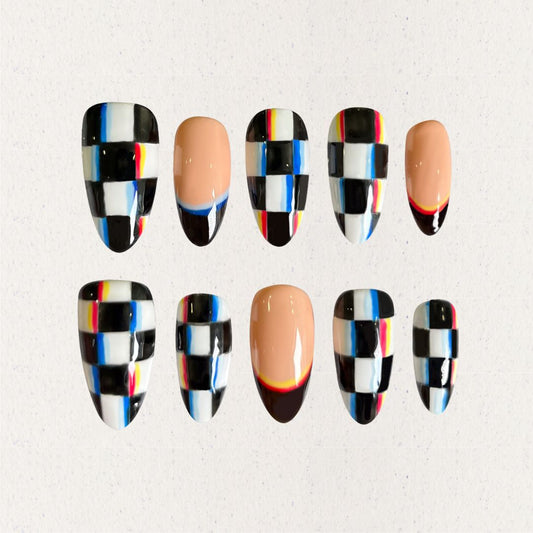 Press-on nails with bold checkered patterns in black, white, and colorful stripes, blending modern and retro vibes.