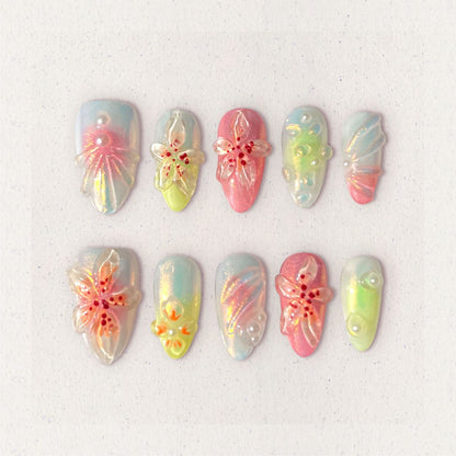 Pastel press-on nails with translucent 3D flowers, soft shimmer, and pearl accents for a dreamy and feminine vibe.