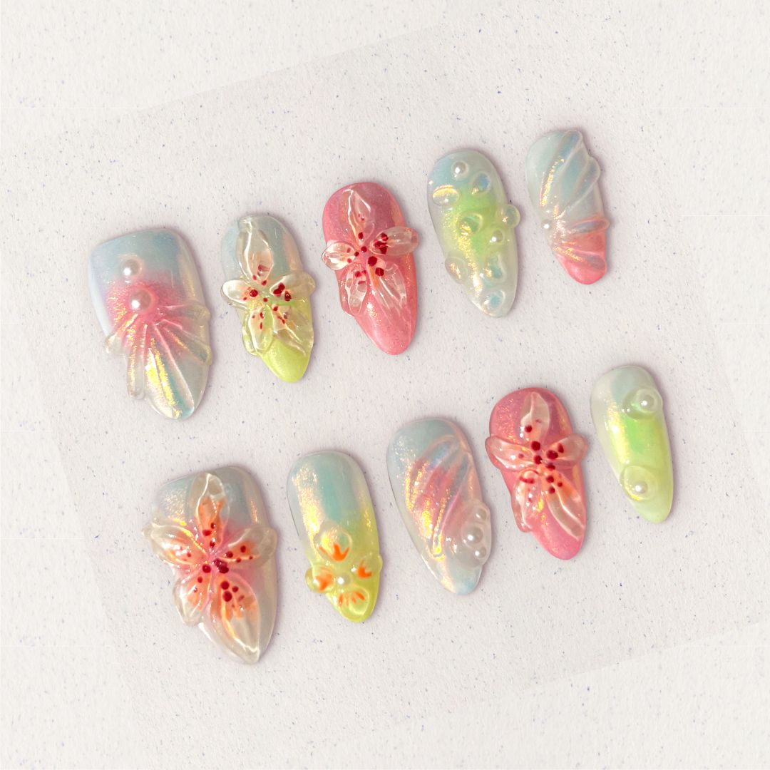 Pastel press-on nails with translucent 3D flowers, soft shimmer, and pearl accents for a dreamy and feminine vibe.