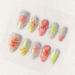 Pastel press-on nails with translucent 3D flowers, soft shimmer, and pearl accents for a dreamy and feminine vibe.