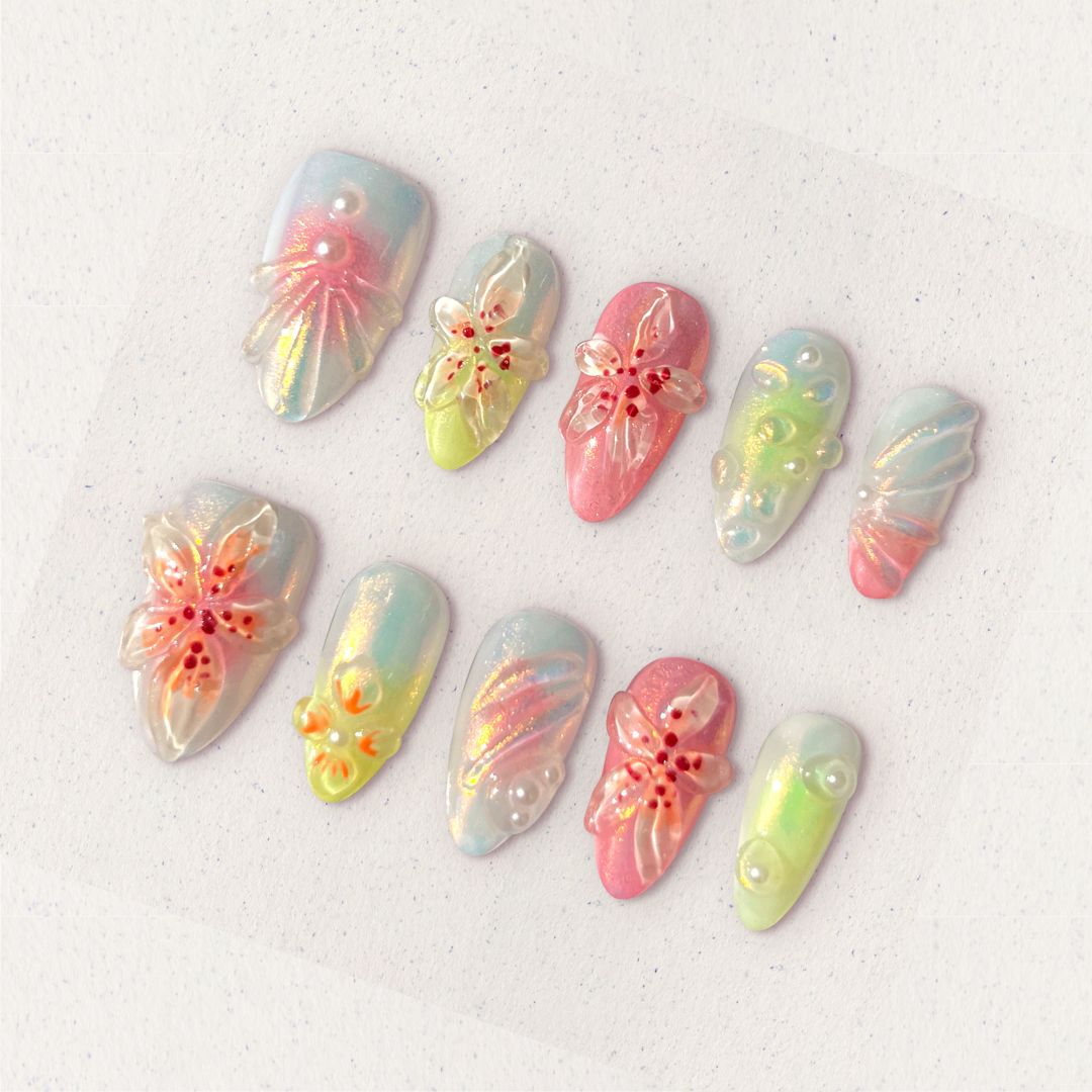 Pastel press-on nails with translucent 3D flowers, soft shimmer, and pearl accents for a dreamy and feminine vibe.