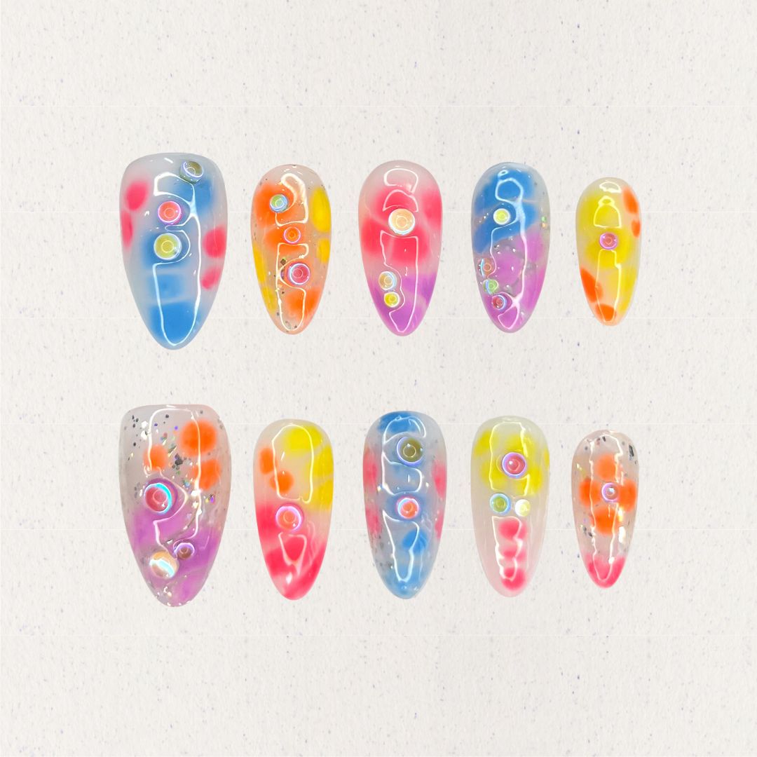 Vibrant press-on nails with dynamic abstract designs in red, orange, and yellow tones, featuring bold, swirling patterns for an energetic look.