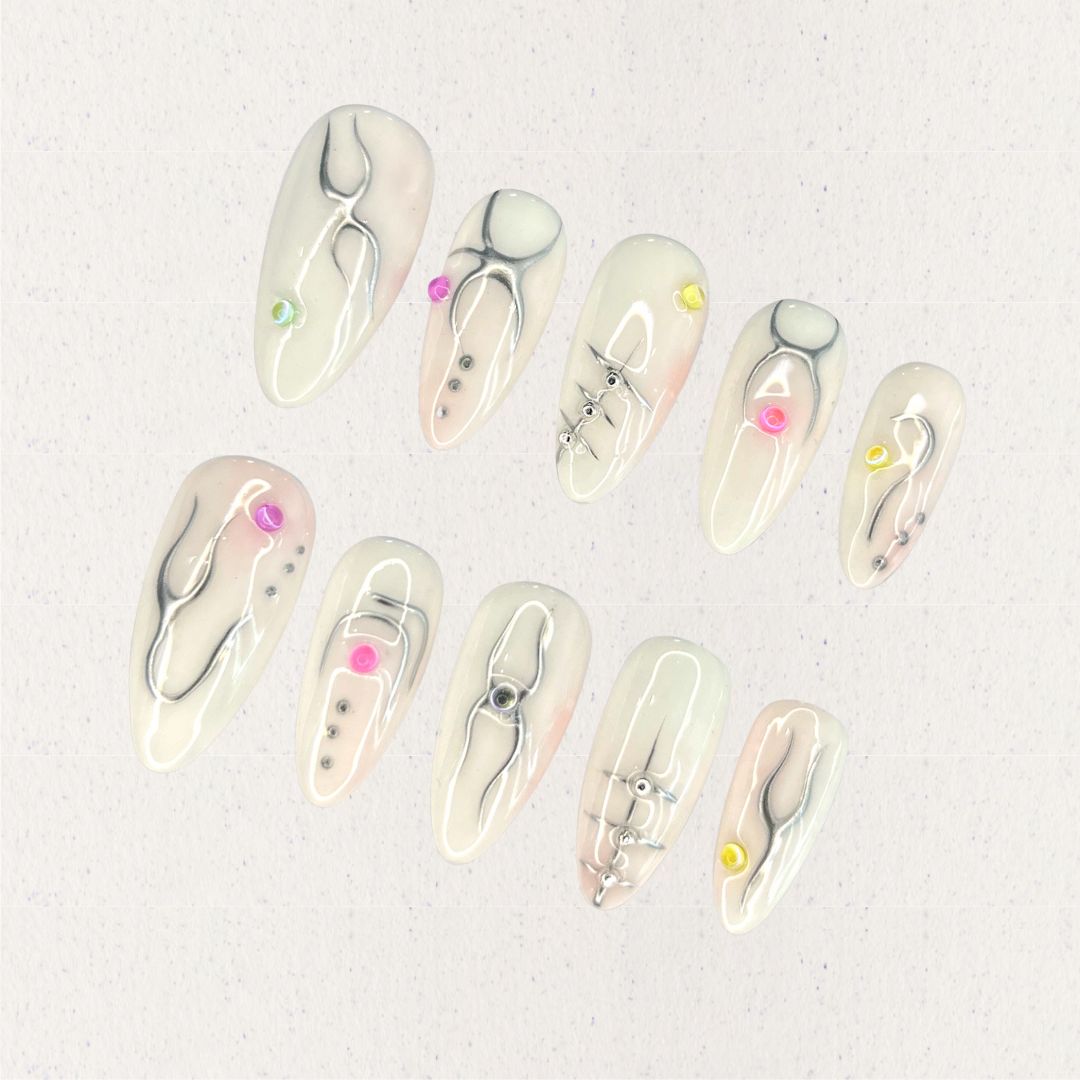 Crystal Blossom nail set features soft pastel shades adorned with hand-painted floral patterns and crystal details, evoking the charm of a blooming garden.