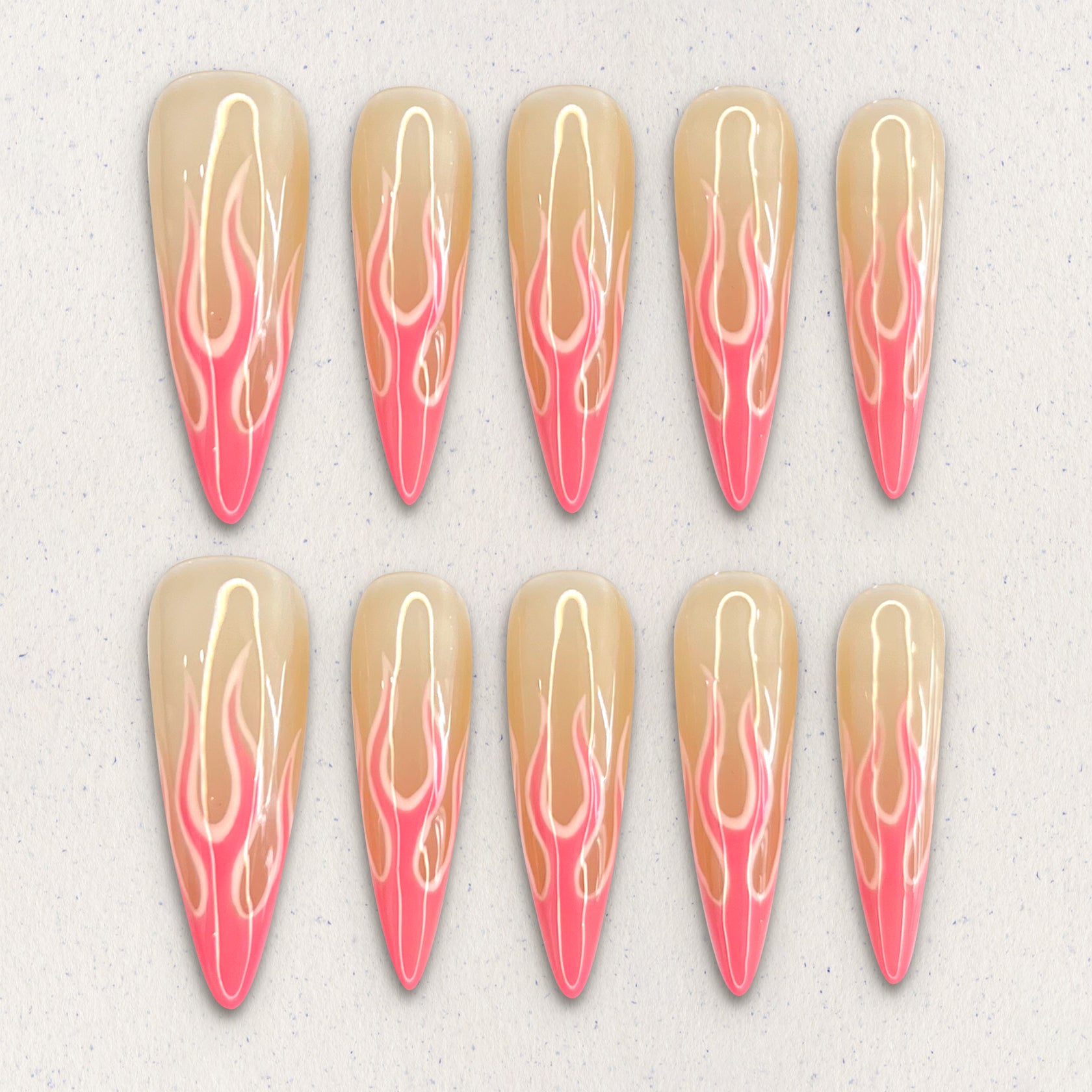 Flaming Elegance nail set features fiery flame patterns in soft coral and peach tones, evoking warmth and sophistication in every detail.