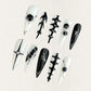 Monochrome Harmony nail set features a sharp black-and-white palette with geometric and abstract patterns, creating a timeless, high-contrast look.