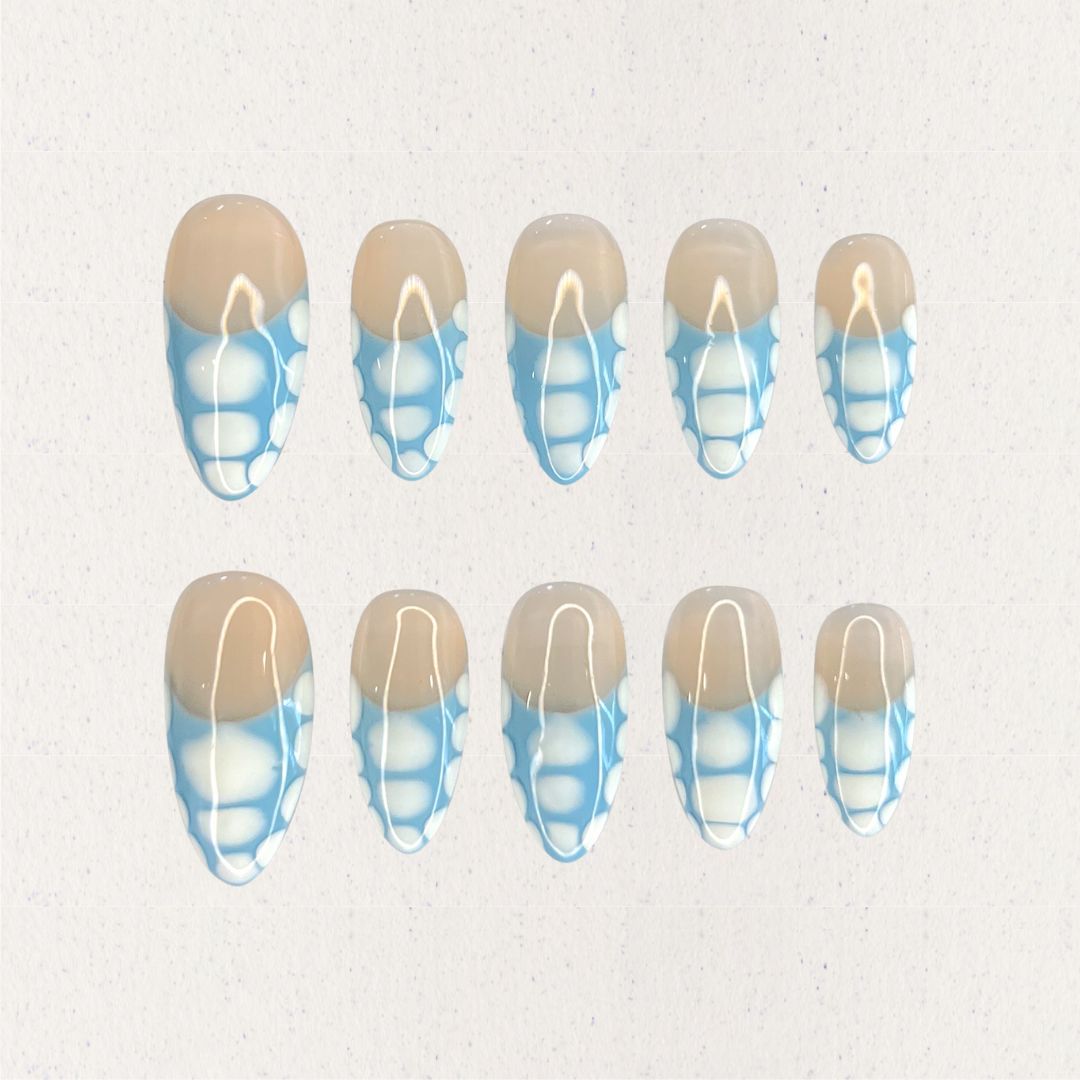 Porcelain Grace press-on nails with a beige base and intricate blue-and-white geometric details. Inspired by the artistry of classic porcelain, this design adds a touch of refinement to your look.