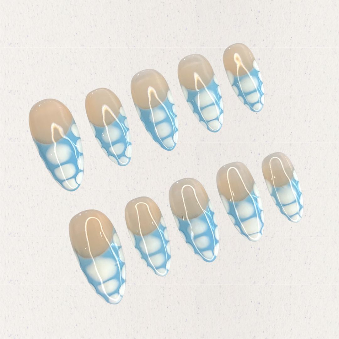 Porcelain Grace press-on nails with a beige base and intricate blue-and-white geometric details. Inspired by the artistry of classic porcelain, this design adds a touch of refinement to your look.