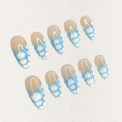 Porcelain Grace press-on nails with a beige base and intricate blue-and-white geometric details. Inspired by the artistry of classic porcelain, this design adds a touch of refinement to your look.