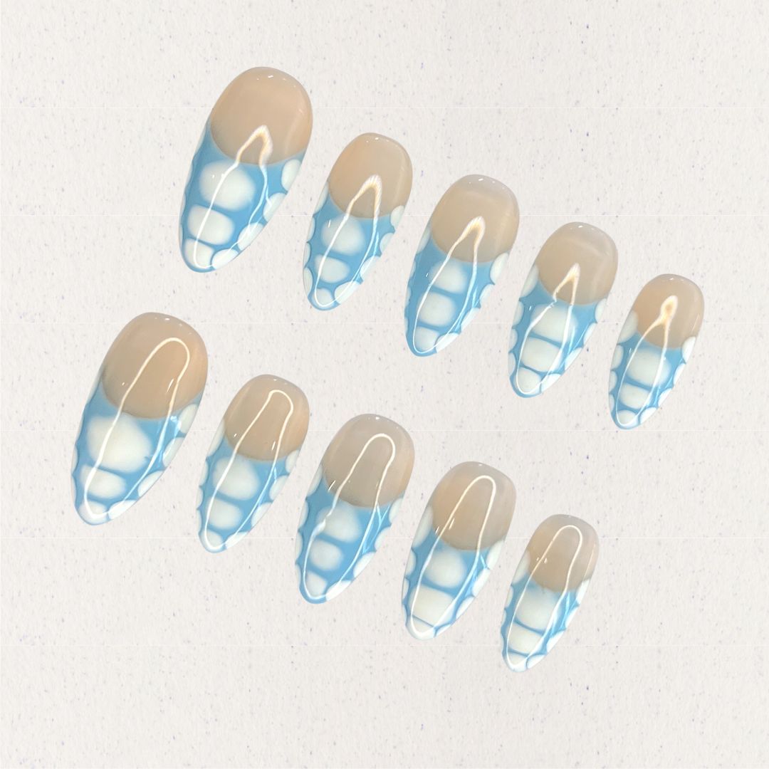 Porcelain Grace press-on nails with a beige base and intricate blue-and-white geometric details. Inspired by the artistry of classic porcelain, this design adds a touch of refinement to your look.