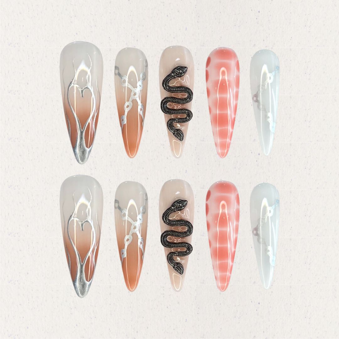 Serpent Elegance nail set includes silver snake accents, soft gradient colors, and fine line details, creating a dramatic and enchanting aesthetic.