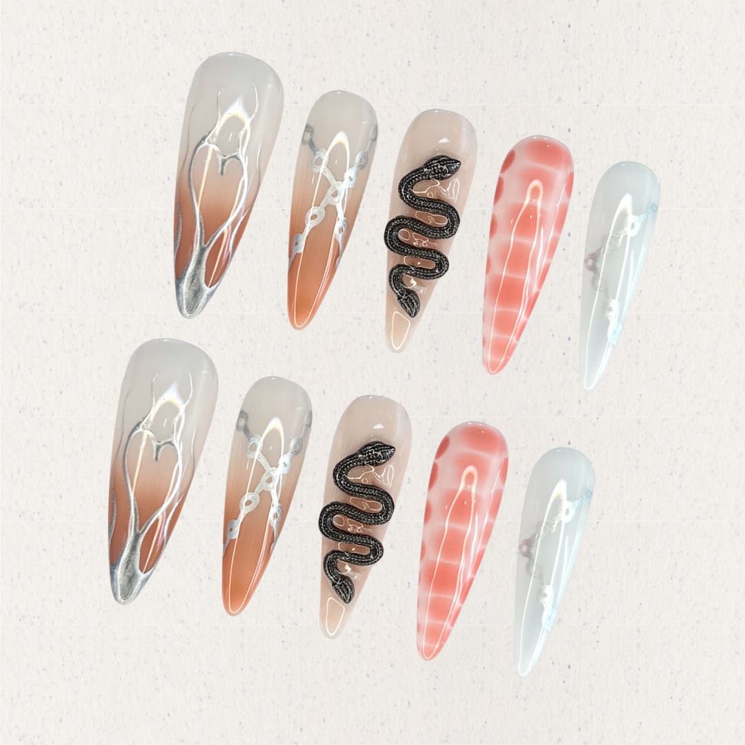 Serpent Elegance nail set includes silver snake accents, soft gradient colors, and fine line details, creating a dramatic and enchanting aesthetic.