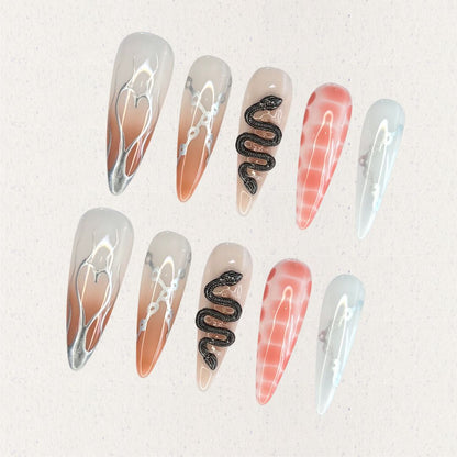 Serpent Elegance nail set includes silver snake accents, soft gradient colors, and fine line details, creating a dramatic and enchanting aesthetic.