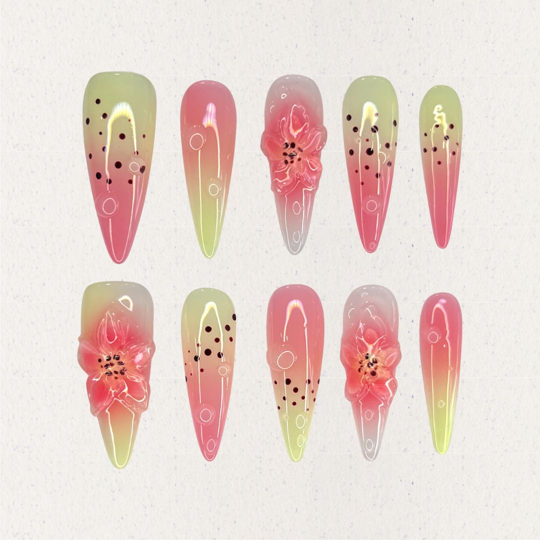 Blooming Bliss highlights pink and green ombre nails with delicate 3D flowers and dotted patterns, embodying the charm of blooming nature.