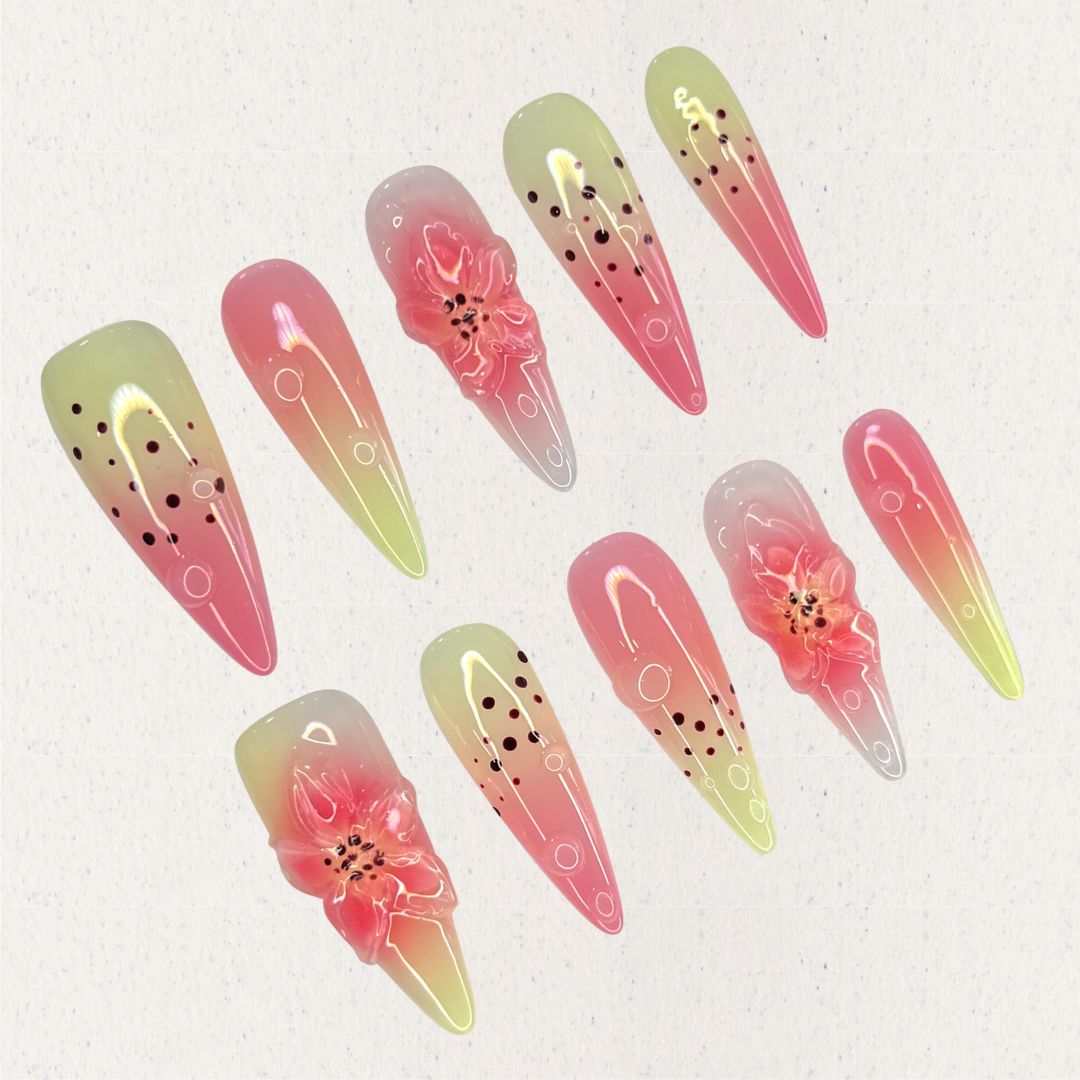 Blooming Bliss highlights pink and green ombre nails with delicate 3D flowers and dotted patterns, embodying the charm of blooming nature.