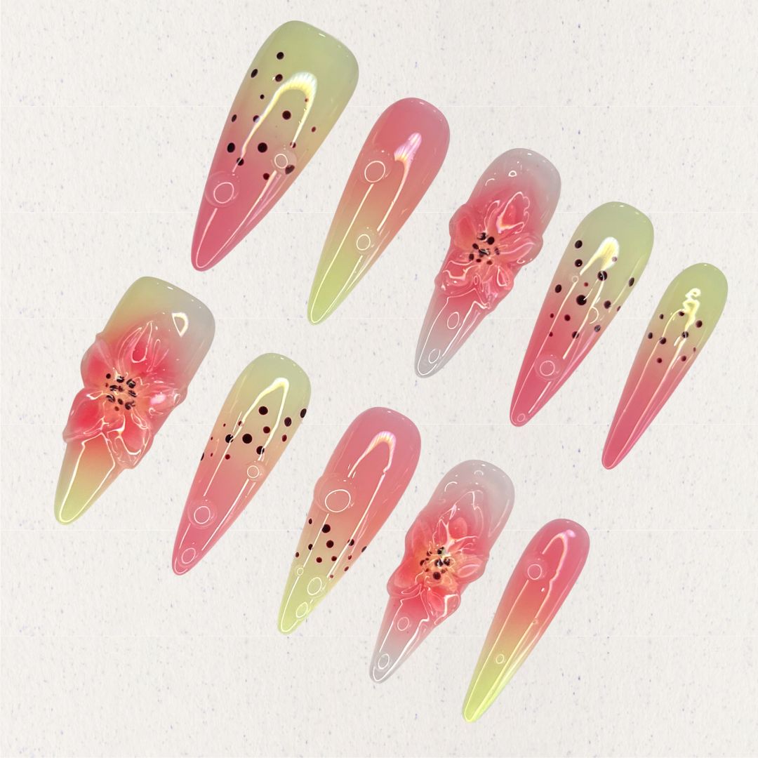 Blooming Bliss highlights pink and green ombre nails with delicate 3D flowers and dotted patterns, embodying the charm of blooming nature.