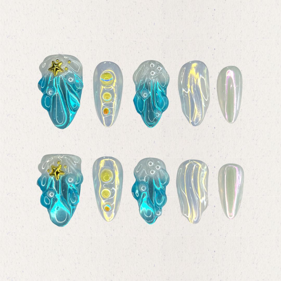 This set of press-on nails, titled "Celestial Waves," features flowing ocean-inspired blue patterns, accented by iridescent pearl white and golden star embellishments. Each nail has a distinct design, including wave-like swirls, translucent gradients, and metallic highlights. The combination creates a serene, celestial look with a minimalist and artistic feel.