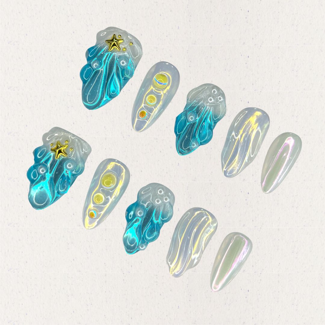 This set of press-on nails, titled "Celestial Waves," features flowing ocean-inspired blue patterns, accented by iridescent pearl white and golden star embellishments. Each nail has a distinct design, including wave-like swirls, translucent gradients, and metallic highlights. The combination creates a serene, celestial look with a minimalist and artistic feel.