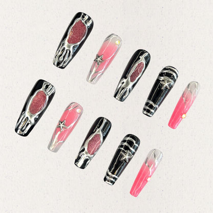 Celestial Veil nail set features dramatic black and pink gradients, accented with metallic textures and silver star embellishments. This design evokes the elegance of a starlit galaxy, wrapped in an enigmatic cosmic veil.