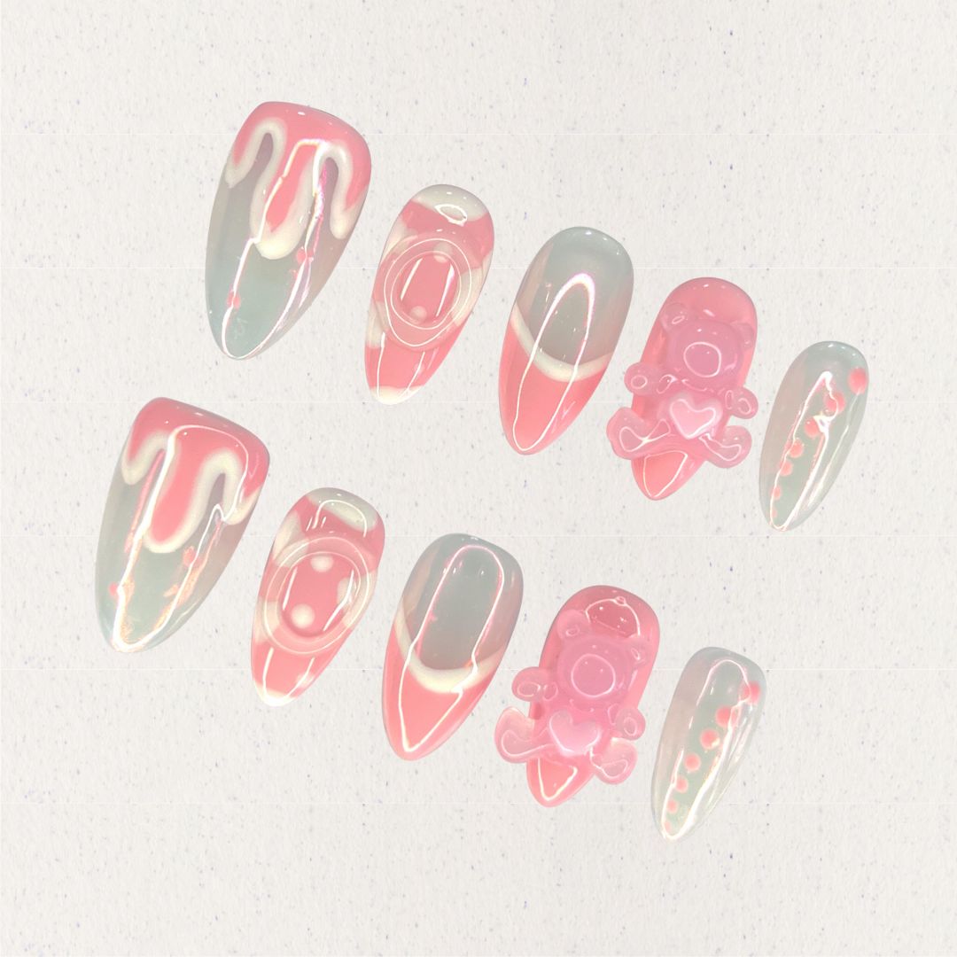 Sweet Whimsy nail set showcases a blend of soft pink and white tones, with smooth curves and 3D teddy bear embellishments. This design evokes a sense of nostalgia and playful joy, perfect for a whimsical touch.