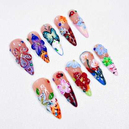 The Blossom Oasis nail set showcases beautiful, detailed 3D flowers and butterflies in a spectrum of vivid colors. Each nail exudes the lushness of a blooming garden, combining artistry with elegance. Ideal for nature lovers and those looking to add a splash of color to their look.