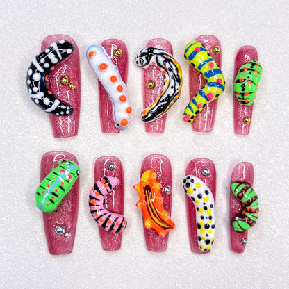 A vibrant press-on nail set adorned with cute caterpillars and tiny animal designs, bringing a playful, nature-inspired charm to your fingertips.