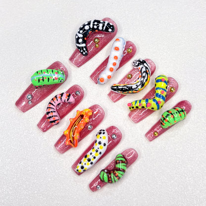 A vibrant press-on nail set adorned with cute caterpillars and tiny animal designs, bringing a playful, nature-inspired charm to your fingertips.