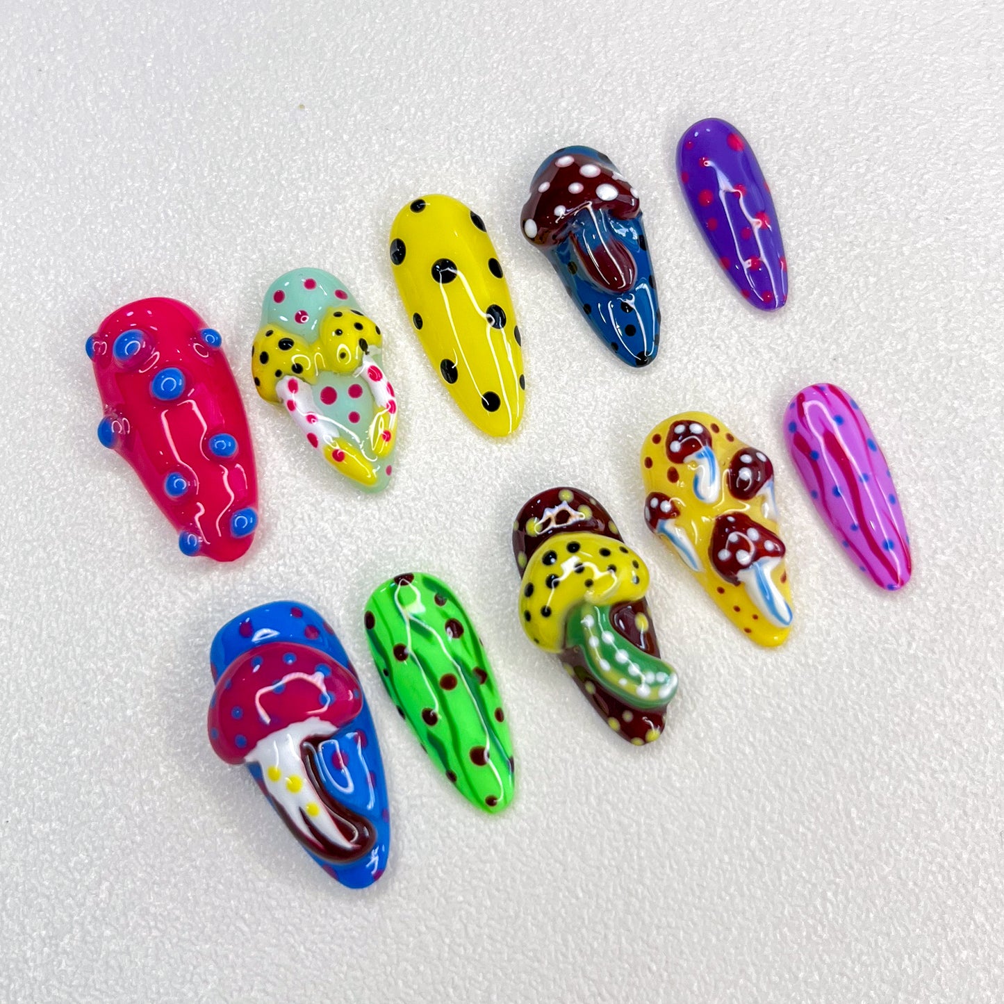 A vibrant press-on nail set with magical mushrooms and playful dot patterns, evoking a fantastical, mystical feel that’s perfect for adding a touch of whimsy and mystery to your style.