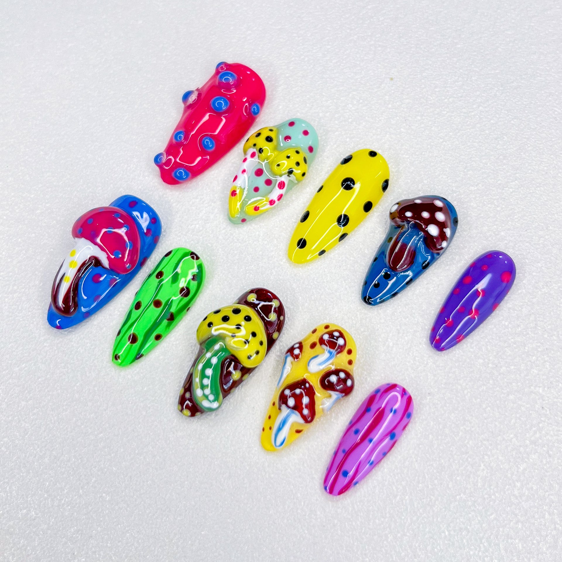 A vibrant press-on nail set with magical mushrooms and playful dot patterns, evoking a fantastical, mystical feel that’s perfect for adding a touch of whimsy and mystery to your style.