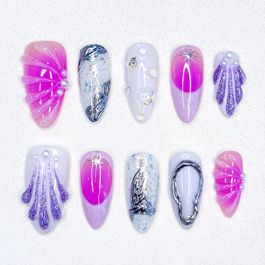 A colorful press-on nail set with purple, rose pink, and blue tones, adorned with seashells and wave designs, bringing a dreamy, mermaid-inspired charm to your style.