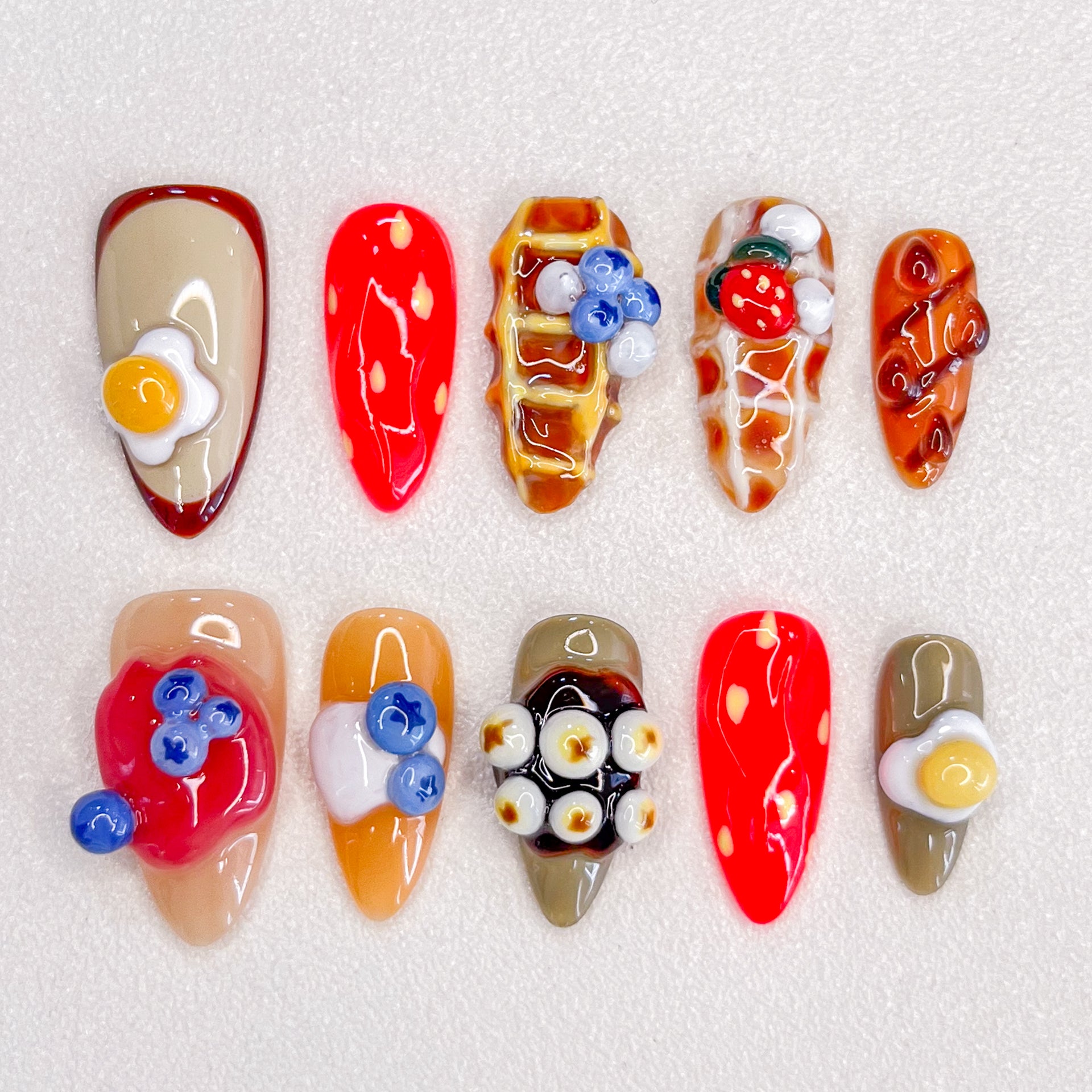 Brunch Bliss press-on nails with breakfast-inspired elements like eggs, waffles, and fruit toppings, perfect for food lovers.