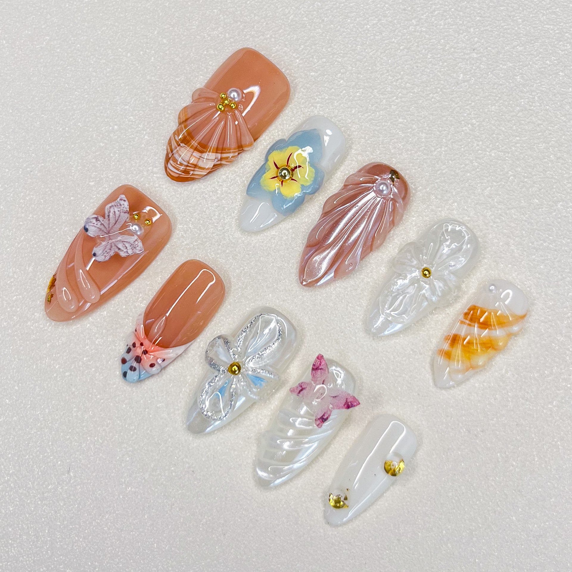 Flutter Fantasy press-on nails with 3D butterflies and delicate flower details, capturing the essence of blooming seasons.