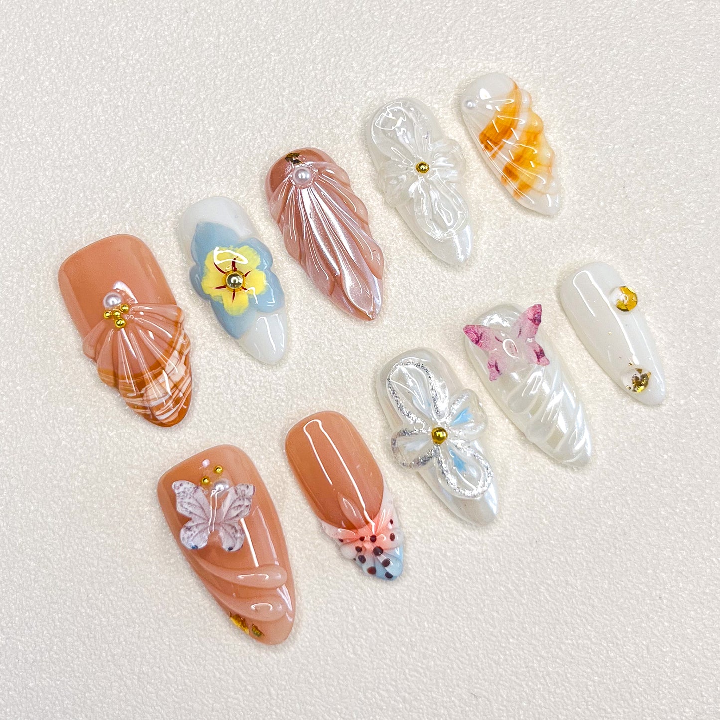 Flutter Fantasy press-on nails with 3D butterflies and delicate flower details, capturing the essence of blooming seasons.