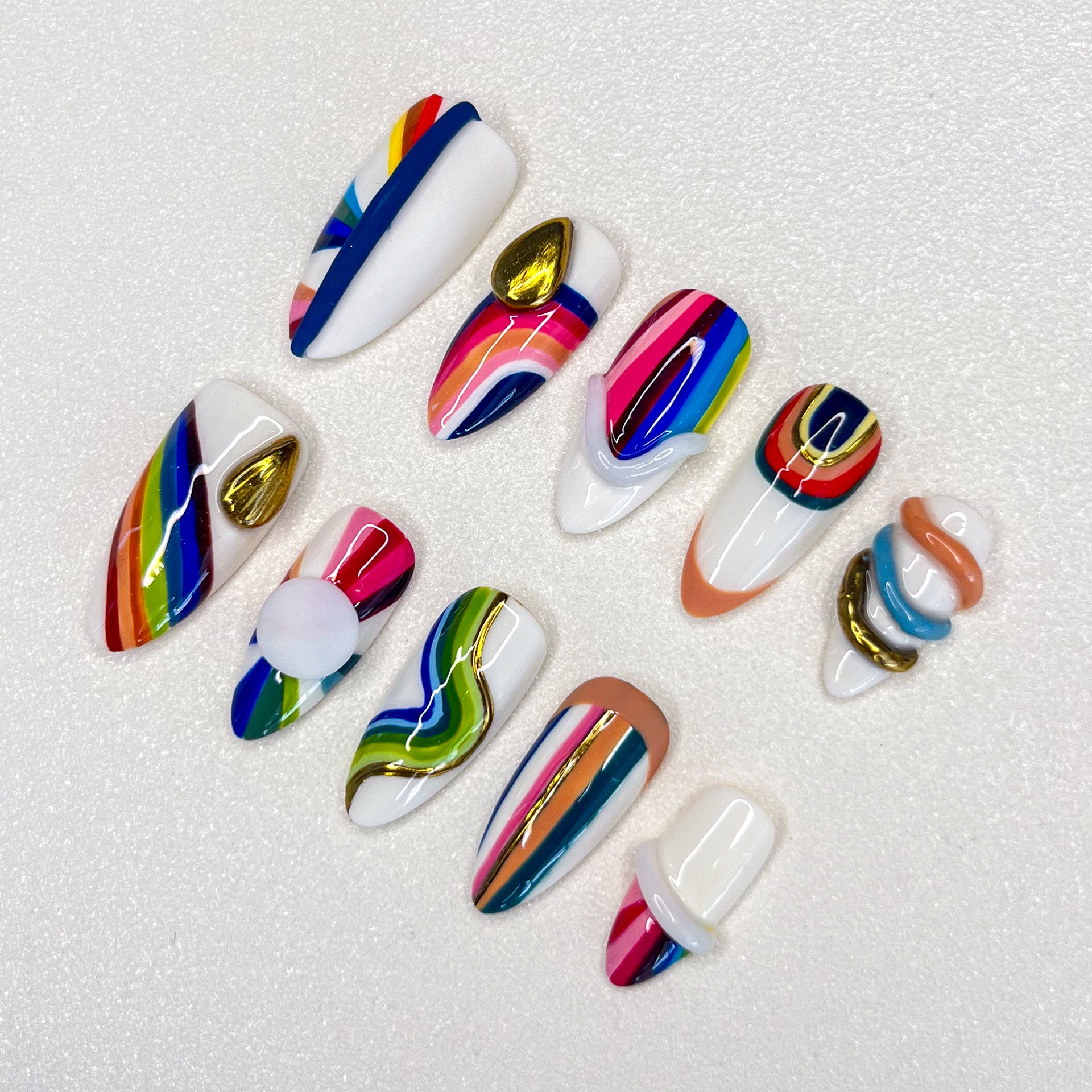 Rainbow Radiance press-on nails with colorful stripes and bold patterns, perfect for a lively and dynamic look.