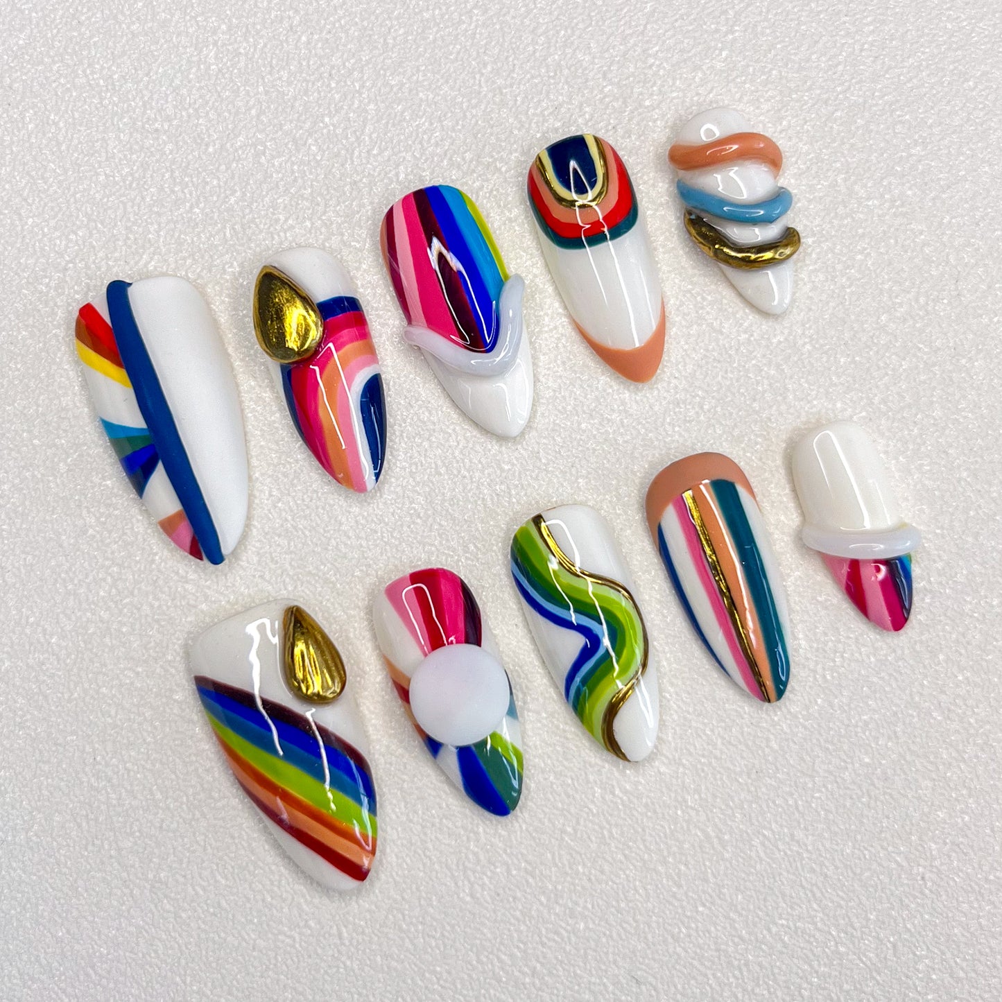 Rainbow Radiance press-on nails with colorful stripes and bold patterns, perfect for a lively and dynamic look.