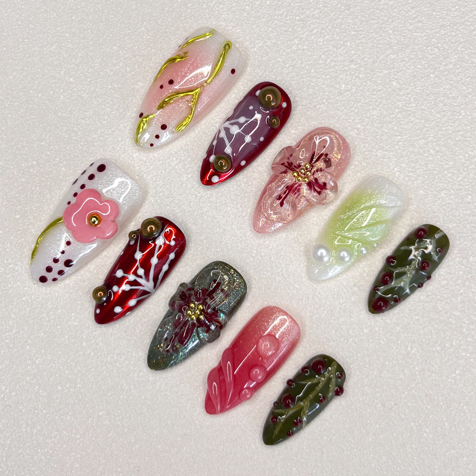 Enchanted Garden press-on nails with hand-painted florals and foliage, perfect for those who love nature-inspired designs.