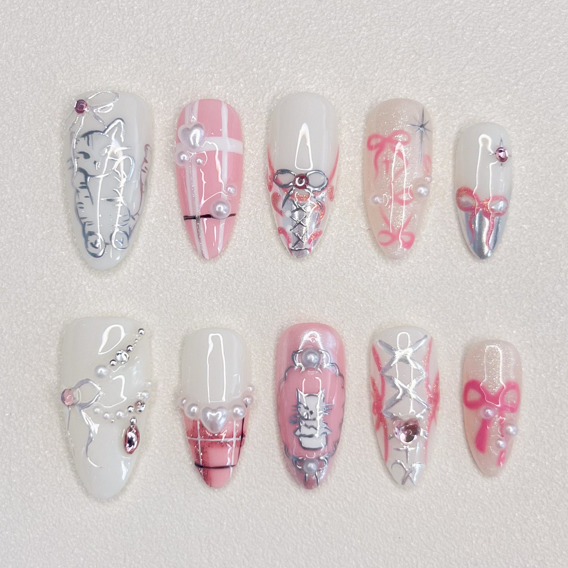 Whisker Whimsy press-on nails with cute cat designs, lace details, and pearls for a fun and sophisticated vibe.