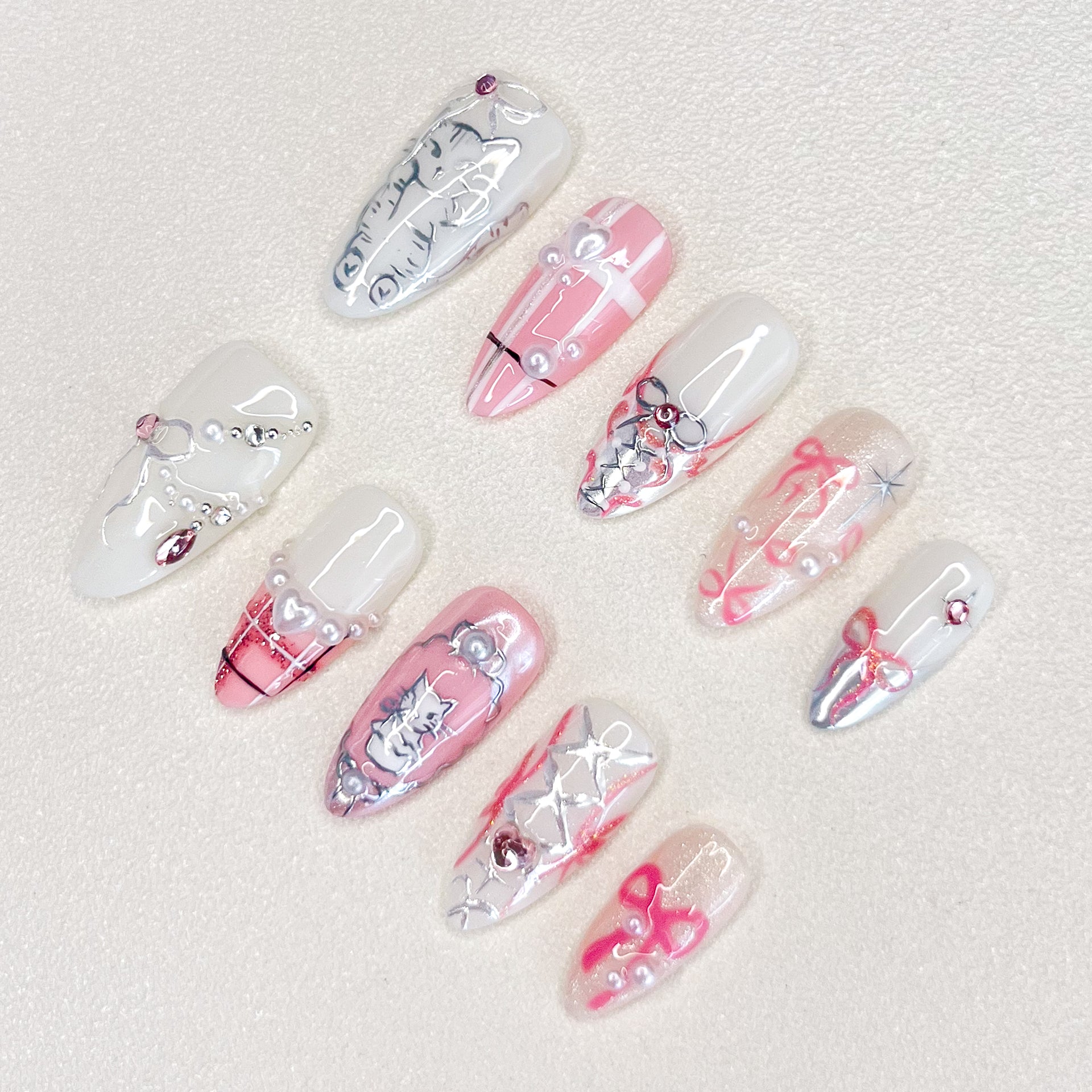 Whisker Whimsy press-on nails with cute cat designs, lace details, and pearls for a fun and sophisticated vibe.