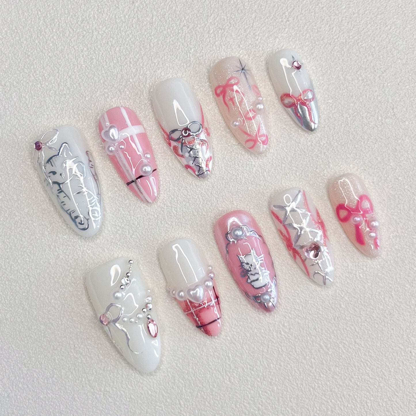 Whisker Whimsy press-on nails with cute cat designs, lace details, and pearls for a fun and sophisticated vibe.