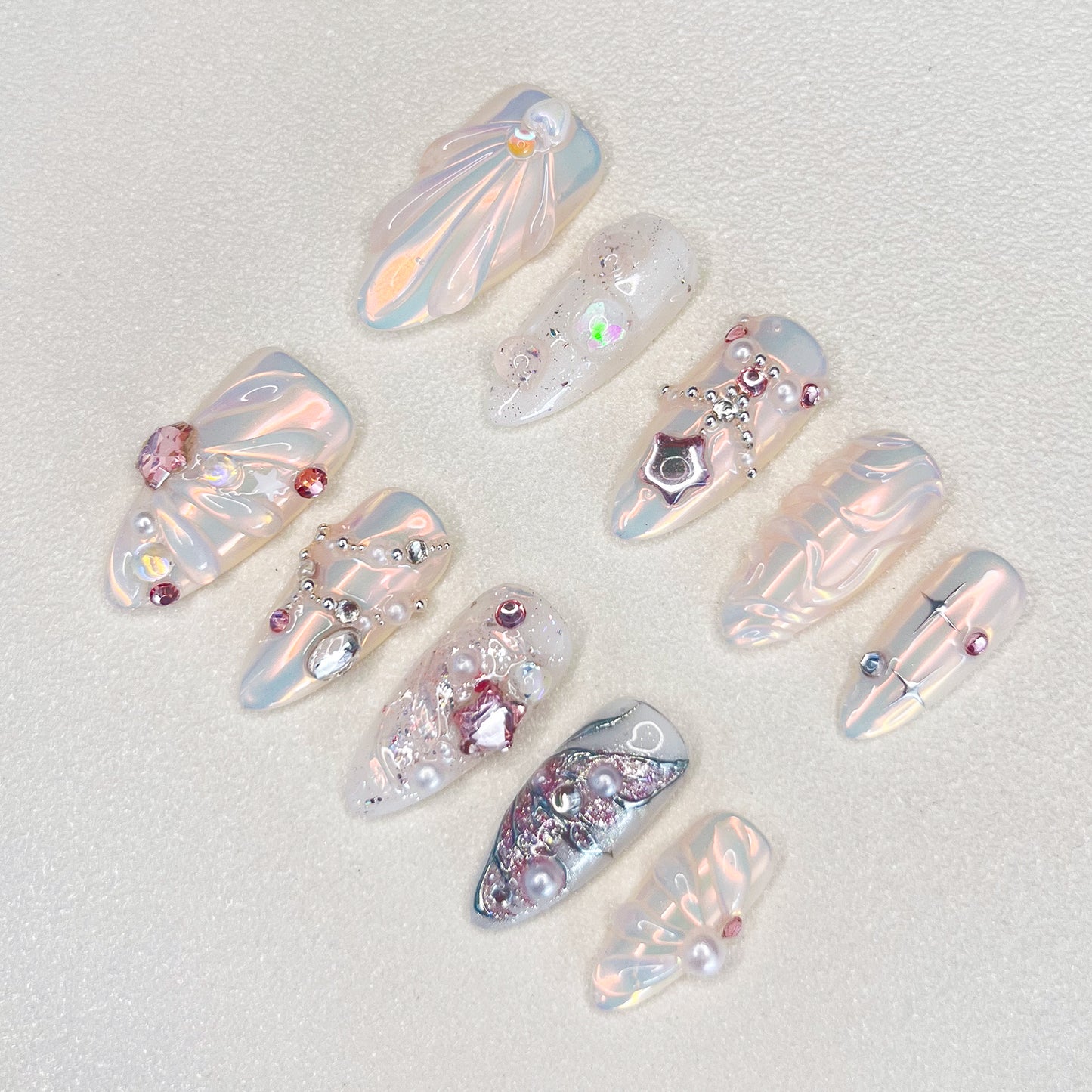 Crystal Radiance press-on nails with a pearly finish, adorned with jewels and crystals for a luxurious, radiant look.