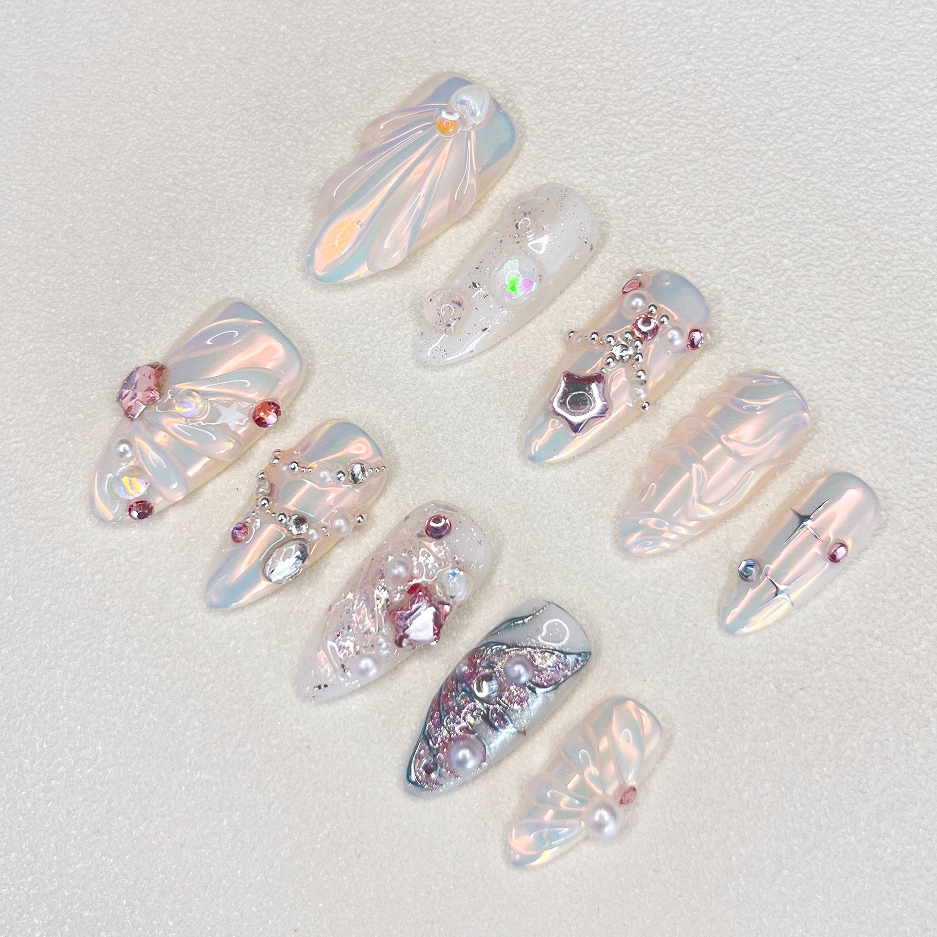 Crystal Radiance press-on nails with a pearly finish, adorned with jewels and crystals for a luxurious, radiant look.