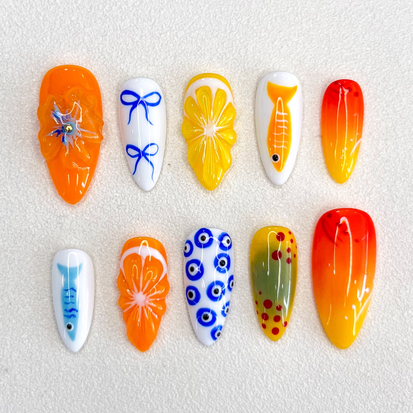 Tropical Sunrise press-on nails with bright orange and yellow designs, inspired by sunny beaches and tropical getaways.