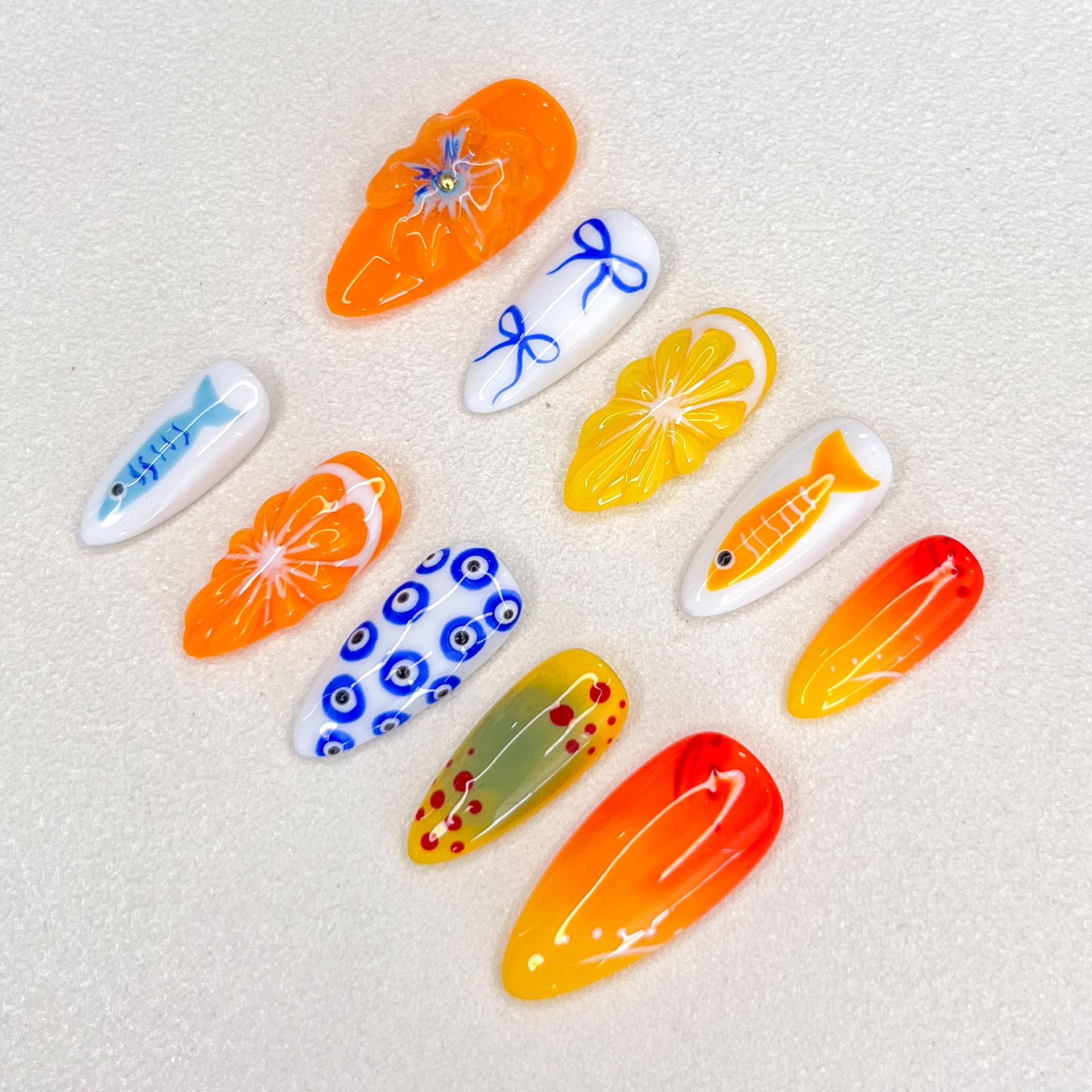 Tropical Sunrise press-on nails with bright orange and yellow designs, inspired by sunny beaches and tropical getaways.