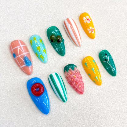 Paradise Vibes press-on nails featuring tropical fruit designs, palm leaves, and vibrant patterns for a fun, vacation-ready style.