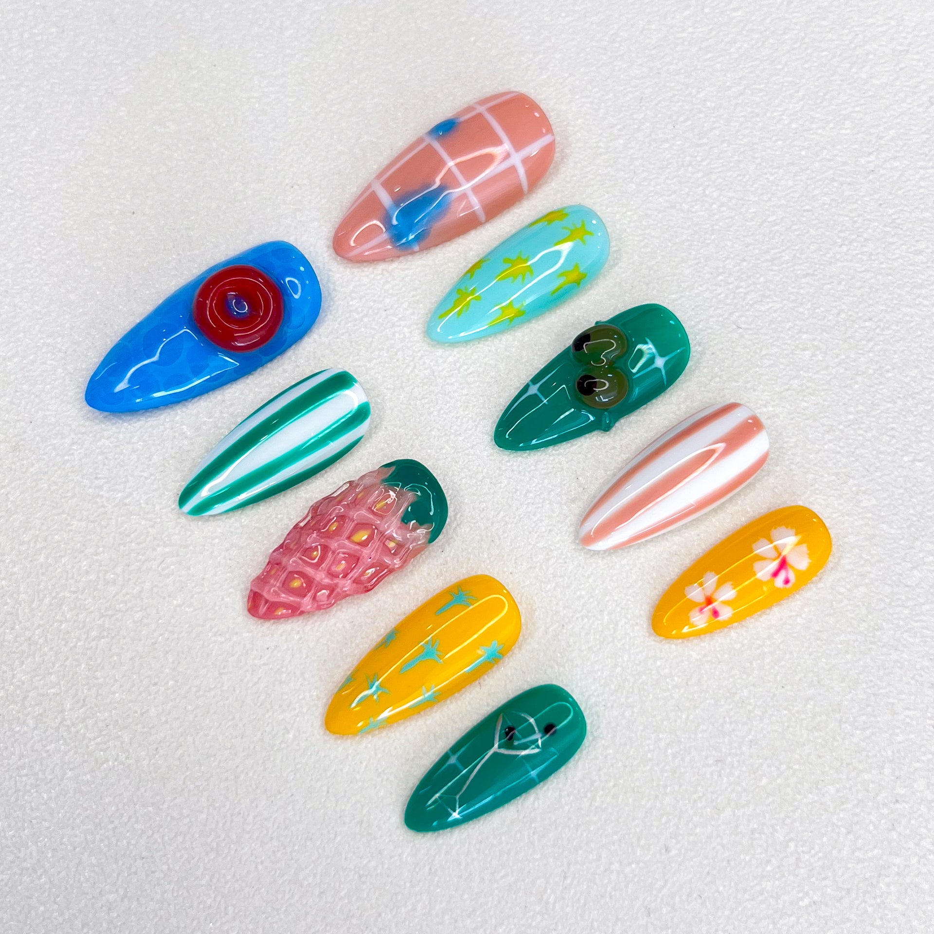 Paradise Vibes press-on nails featuring tropical fruit designs, palm leaves, and vibrant patterns for a fun, vacation-ready style.